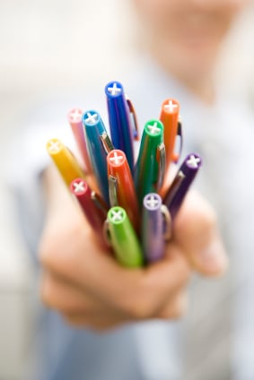 Hand Holding Colored Pens